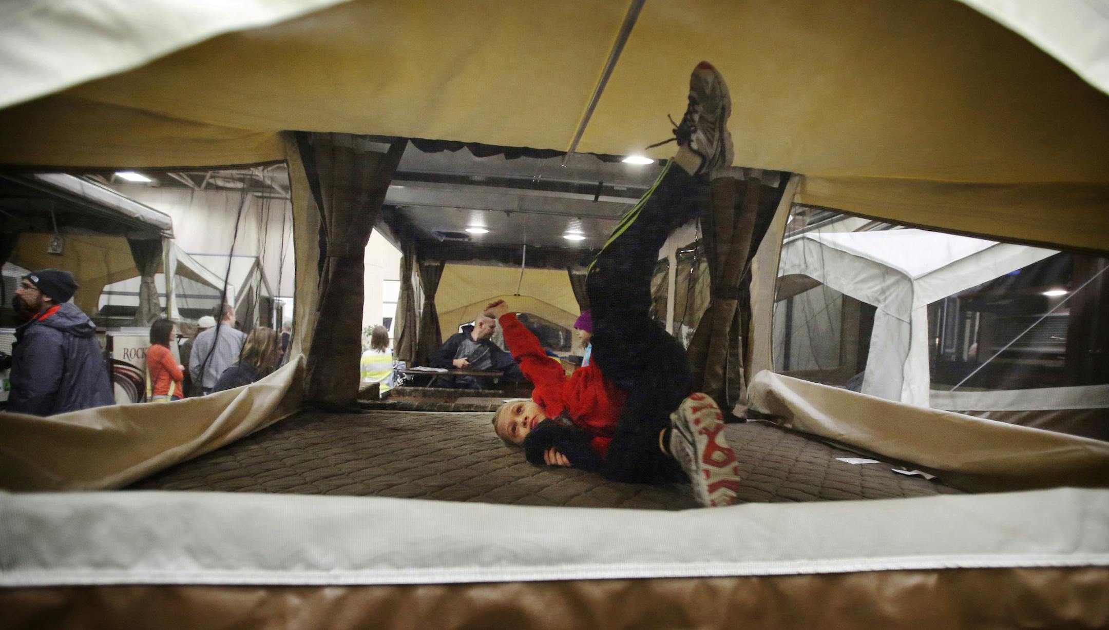 Alex Meyer, 7, of Chaska gives the mattress of a Rockwood Freedom pop up camper a real test while he attended the 49th Annual Minneapolis / St. Paul RV, Vacation & Camping Show with his parents and sister Saturday, Feb. 14, 2015, at the Minneapolis Convention Center in Minneapolis, MN.](DAVID JOLES/STARTRIBUNE)djoles@startribune.com The 49th Annual Minneapolis / St. Paul RV, Vacation & Camping Show was in full swing Saturday, Feb. 14, 2015, at the Minneapolis Convention Center in Minneapolis, MN