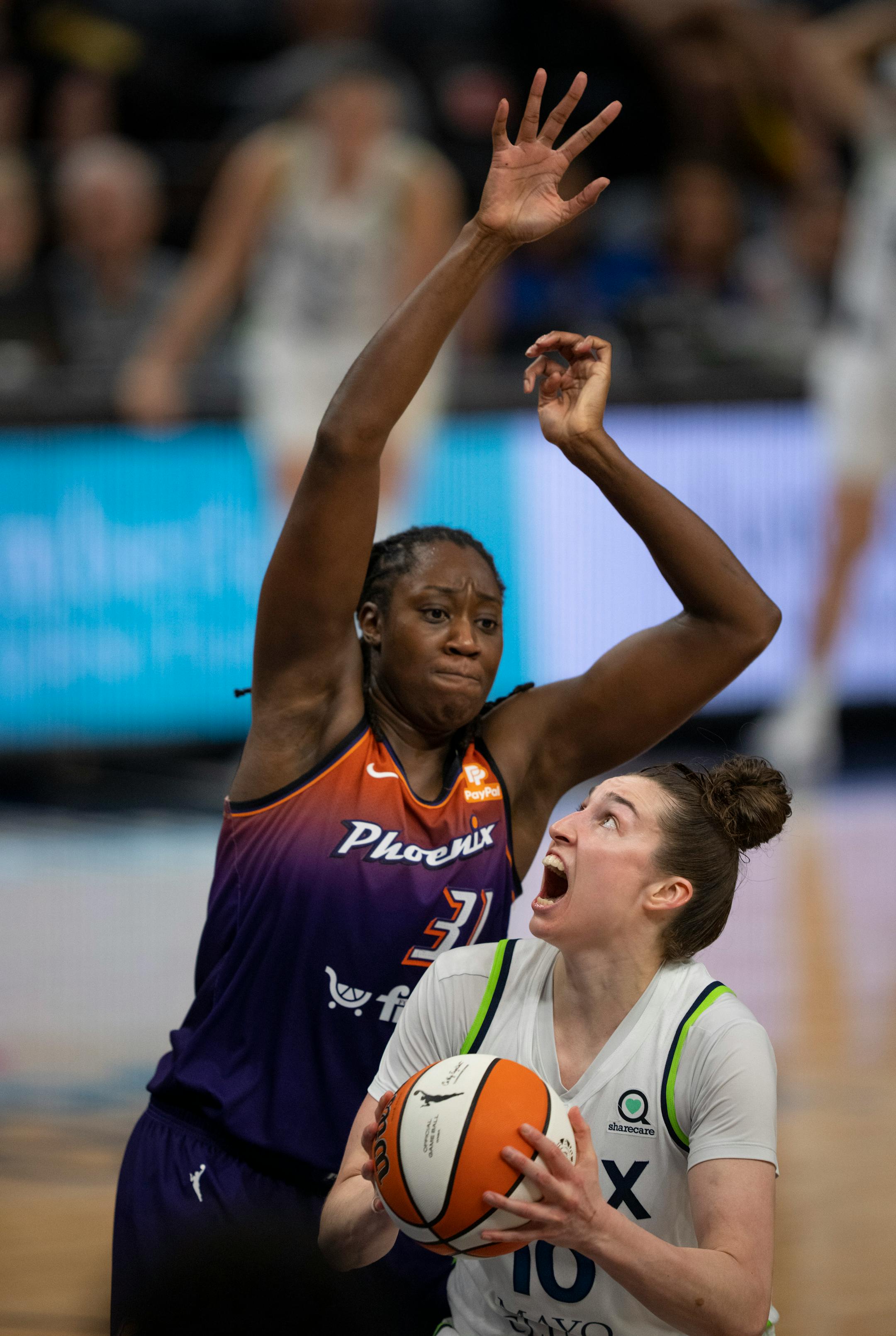 Minnesota Lynx forward Jessica Shepard (10) was fouled by Phoenix Mercury center Tina Charles (31) while shooting in the fourth quarter.