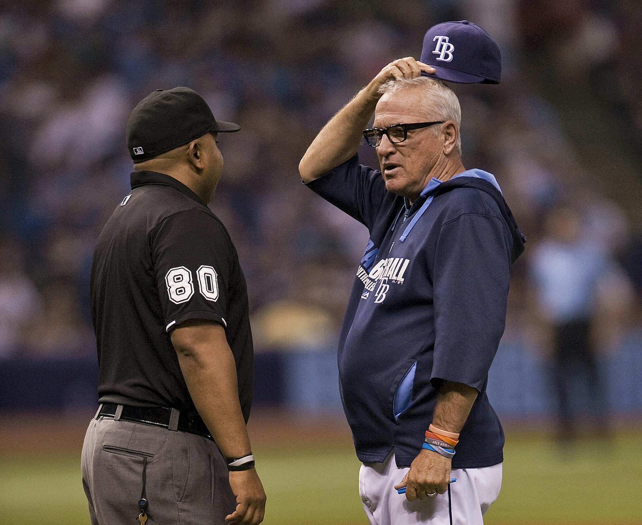 Tampa Bay Rays manager Joe Maddon, right, discusses a call with umpire Adrian Johnson (80) during a baseball game against the Boston Red Sox Saturday, May 24, 2014 in St. Petersburg, Fla. (AP Photo/Steve Nesius) ORG XMIT: SPD207