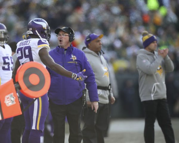 Minnesota Vikings head coach Mike Zimmer and cornerback Xavier Rhodes (29) speak on the sidelines after the Green Bay Packers scored on a second-quart