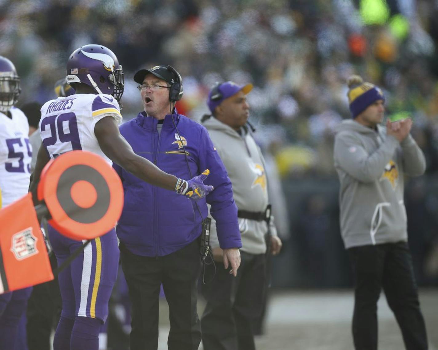 Minnesota Vikings head coach Mike Zimmer and cornerback Xavier Rhodes (29) speak on the sidelines after the Green Bay Packers scored on a second-quarter pass play at Lambeau Field in Green Bay, Wis., on Saturday, Dec. 24, 2016.