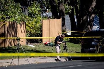 Police and BCA vehicles near a broken piece of fencing at a home at the intersection of Pinewood Ct. and CO RD H2 in Mounds View.