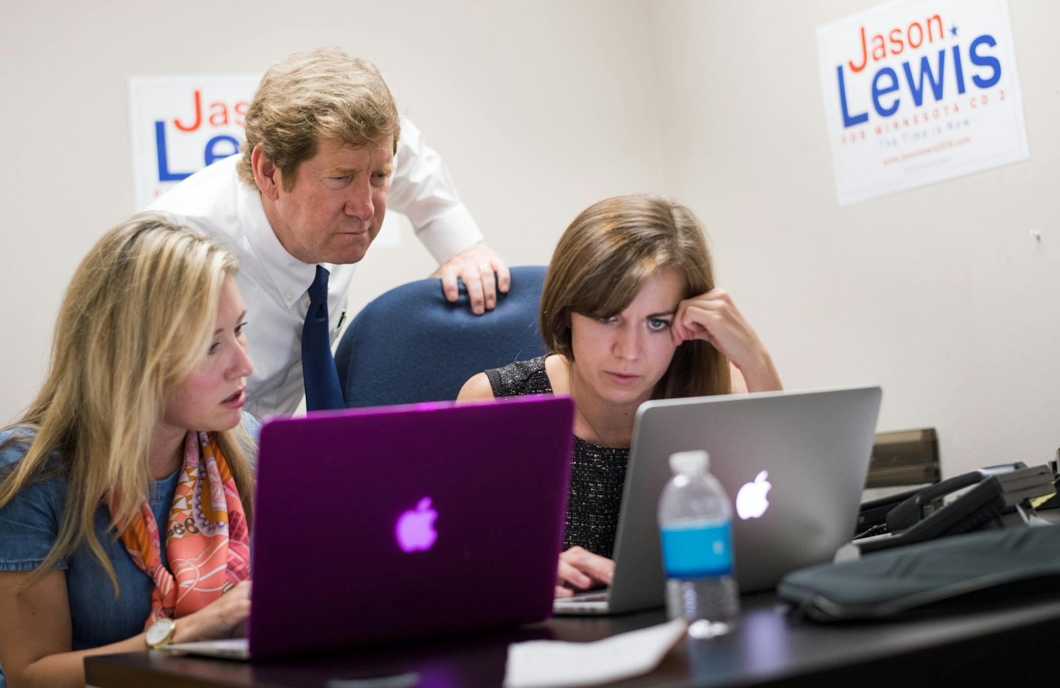 Republican primary candidate Jason Lewis watched as early poll results were posted in his Burnsville campaign headquarters just after the polls closed. He is running against three other Republicans for John Kline's Congressional seat in the second congressional district. The winner of this primary will run against Democrat Angie Craig. L to R are campaign consultants Ashlee Stephenson and Josie Peterson.