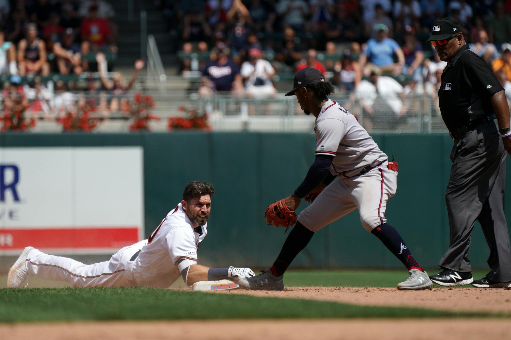 Minnesota Twins center fielder Jake Cave (60) hung onto second base after he a double as Atlanta Braves second baseman Ozzie Albies (1) looked to make the tag in the fifth inning.