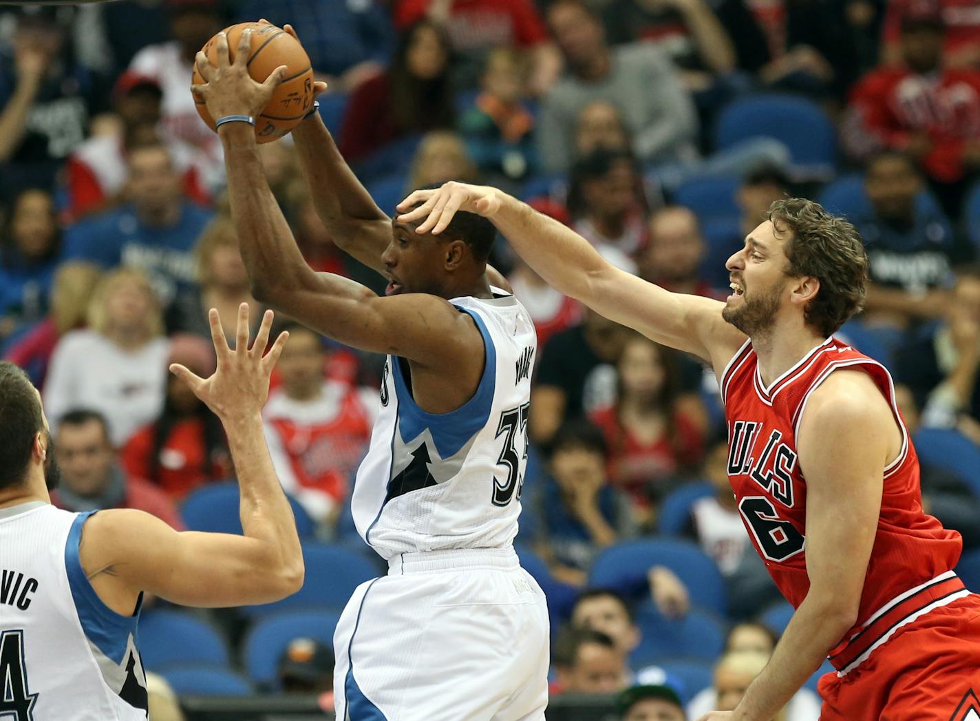 Minnesota Timberwolves' Thaddeus Young, with ball, looks to pass as Chicago Bulls' Pau Gasol of Spain defends in the first quarter of an NBA basketball game, Saturday, Nov. 1, 2014, in Minneapolis. (AP Photo/Jim Mone)