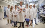 Erik Wambre, center, molecular biologist and head of the Wambre Lab at the Benaroya Research Institute, with colleagues in his lab on August 1, 2017, 