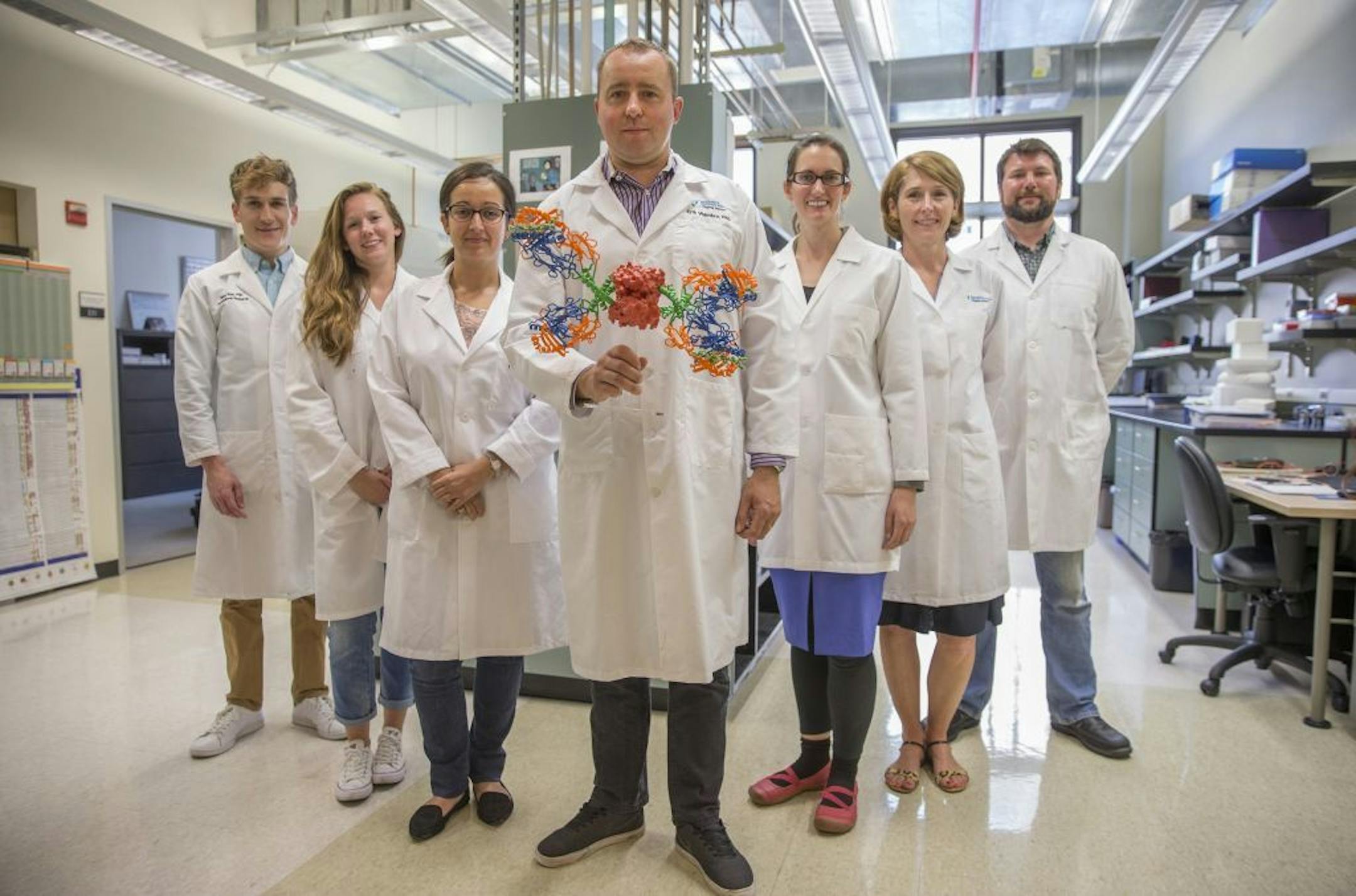 Erik Wambre, center, molecular biologist and head of the Wambre Lab at the Benaroya Research Institute, with colleagues in his lab on August 1, 2017, in Seattle's Capitol Hill neighborhood.