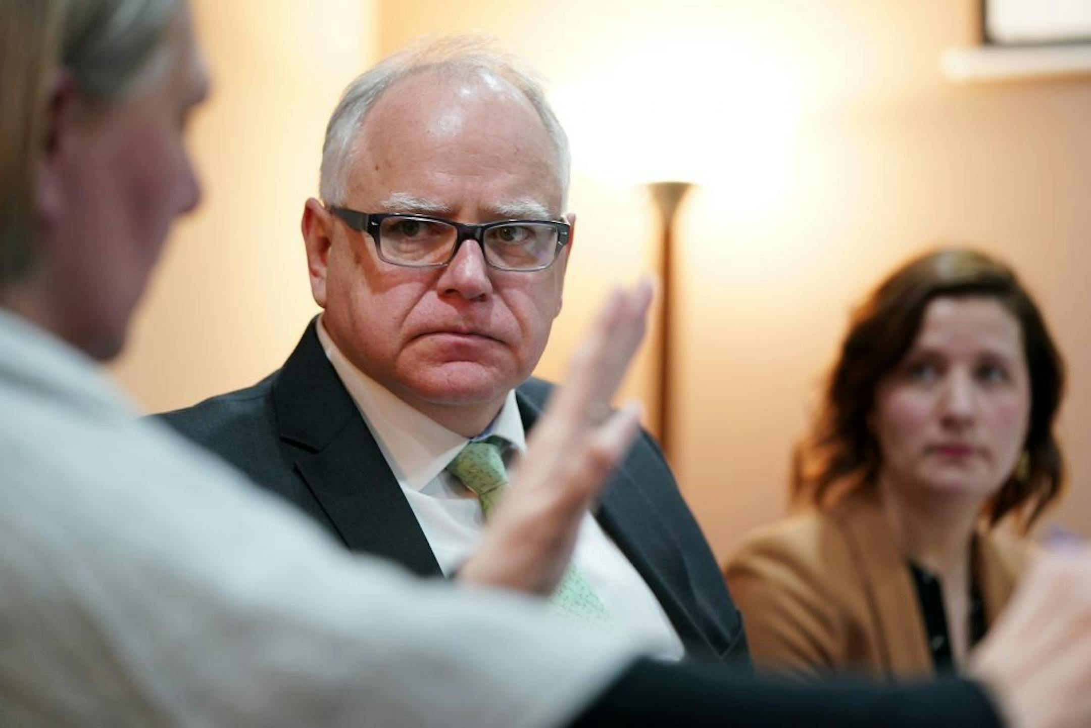 Gov. Tim Walz talked with Catholic Charities navigator Sue Killian during a round table discussion on health care at the Mid-Minnesota Legal Aid in St. Cloud Thursday.