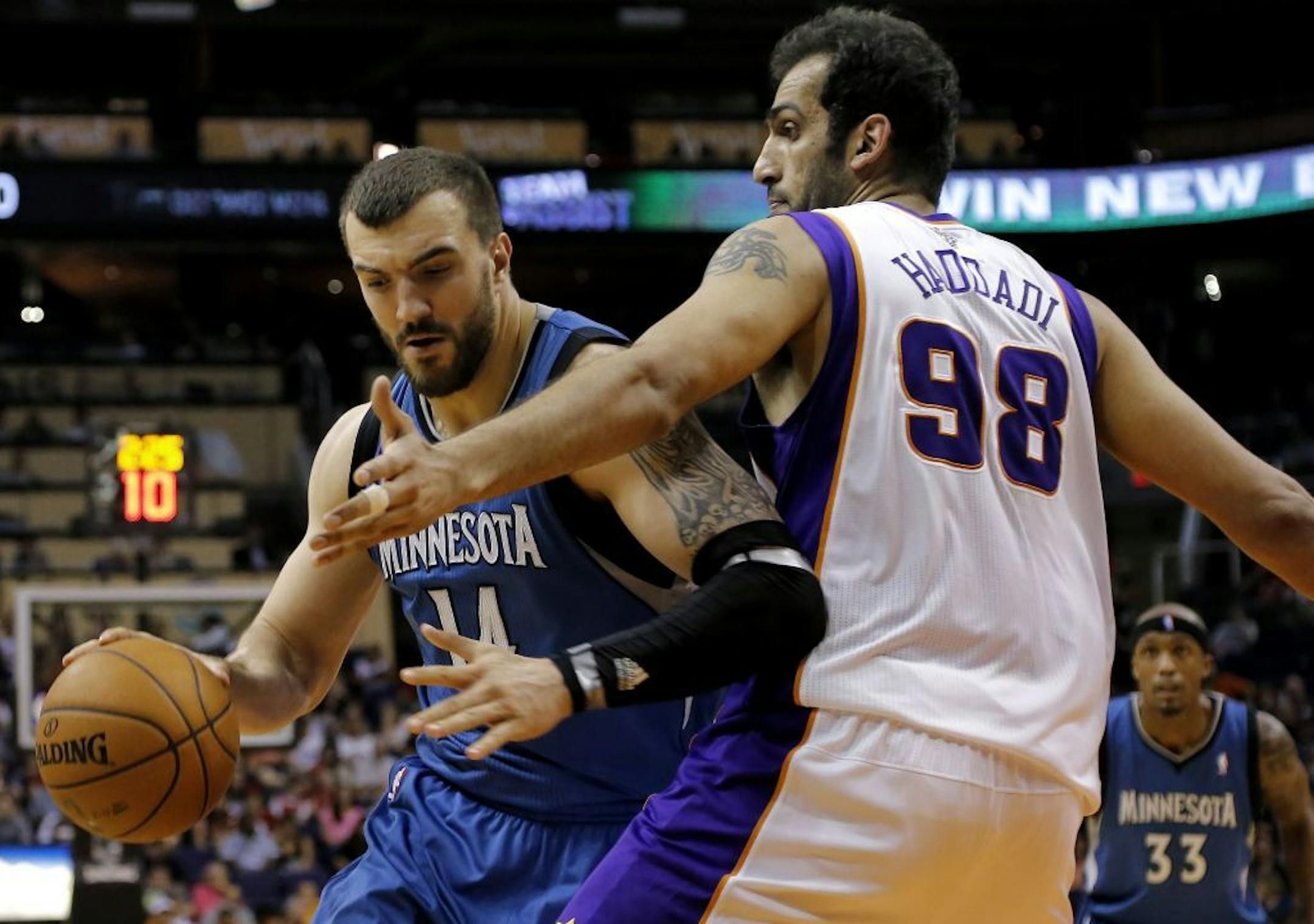 Minnesota Timberwolves' Nikola Pekoic backs down theix Suns' Hamed Haddadi