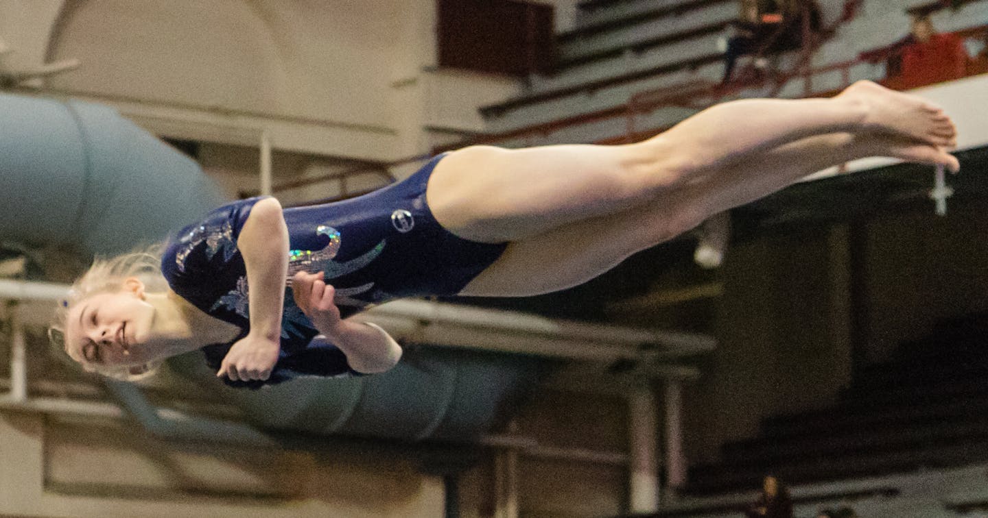 Champlin Park's Chaney Neu mid-jump during the floor exercise, in which she placed first at the Class 2A All-Around championship. ] Photo By: Matt Weber