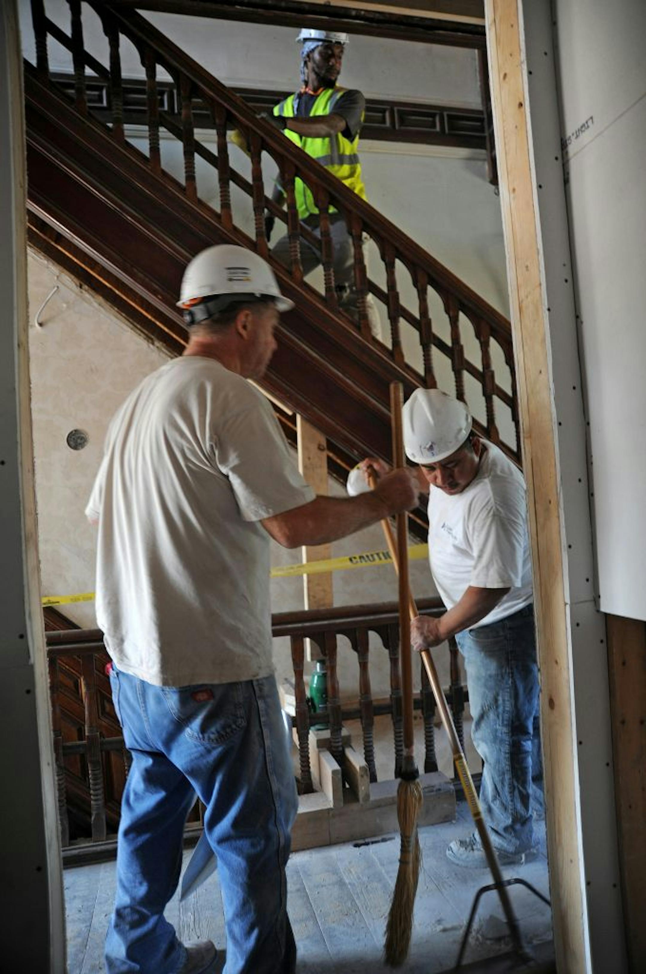 On Aug. 31, workers were renovating the building housing the Minnesota African American Museum and Cultural Center at 1700 3rd Av. S. in Minneapolis. Duane Kaup and Severo Alvarez worked in a hallway while Aubrey Ottley, carpentry foreman, walked up the stairs.
