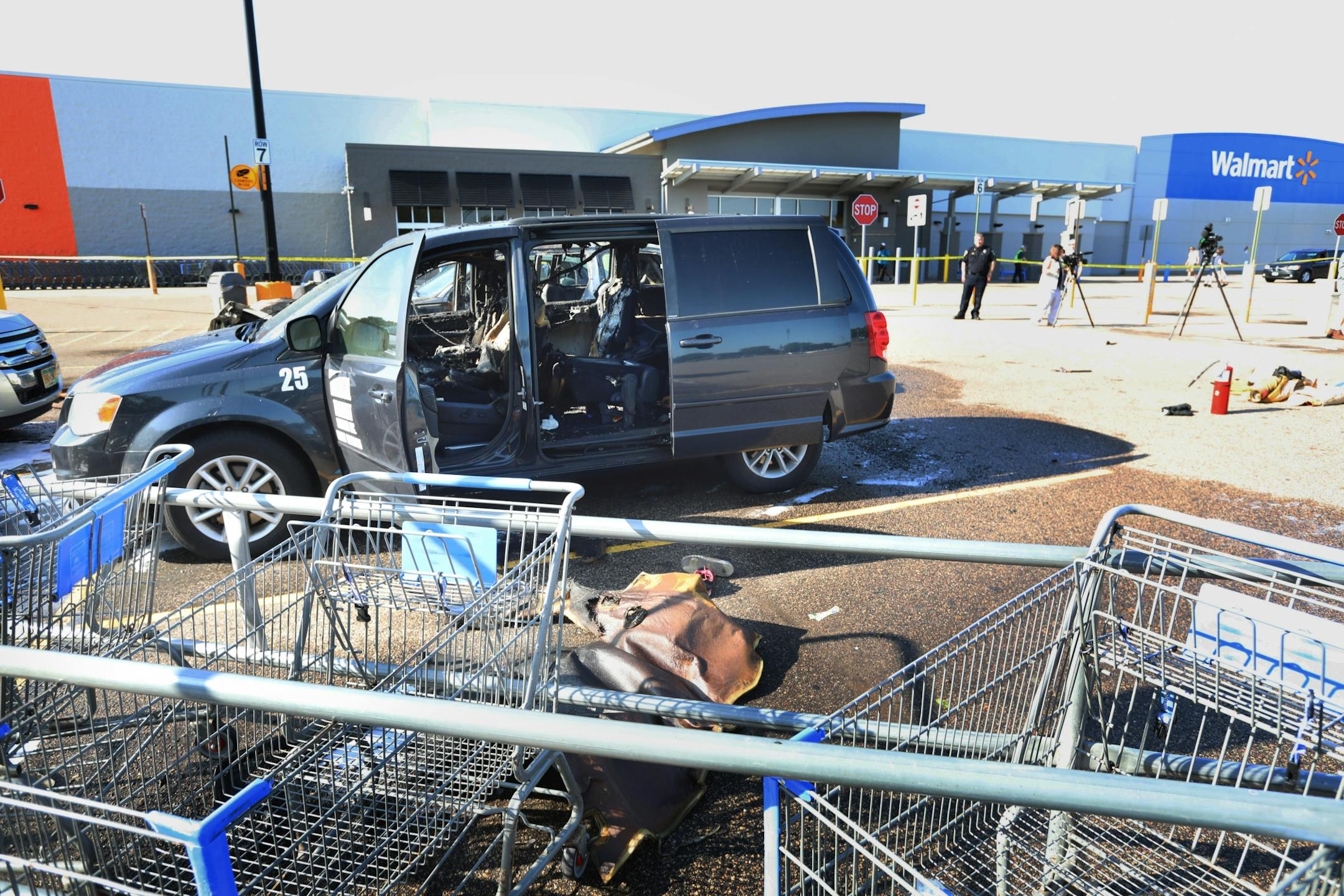 A car fire at a Fridley Walmart engulfed three vehicles and left two young passengers injured in a taxi van parked next to the vehicle where the fire originated Tuesday, Aug. 6, 2019, in Fridley, MN. The scene of a multiple car fire where two children were injured, one critically.