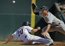At Target Field in a game between the Twins and the Yankees, Eddie Rosario(20) is called out by Garret Jones(33) to make the final out .