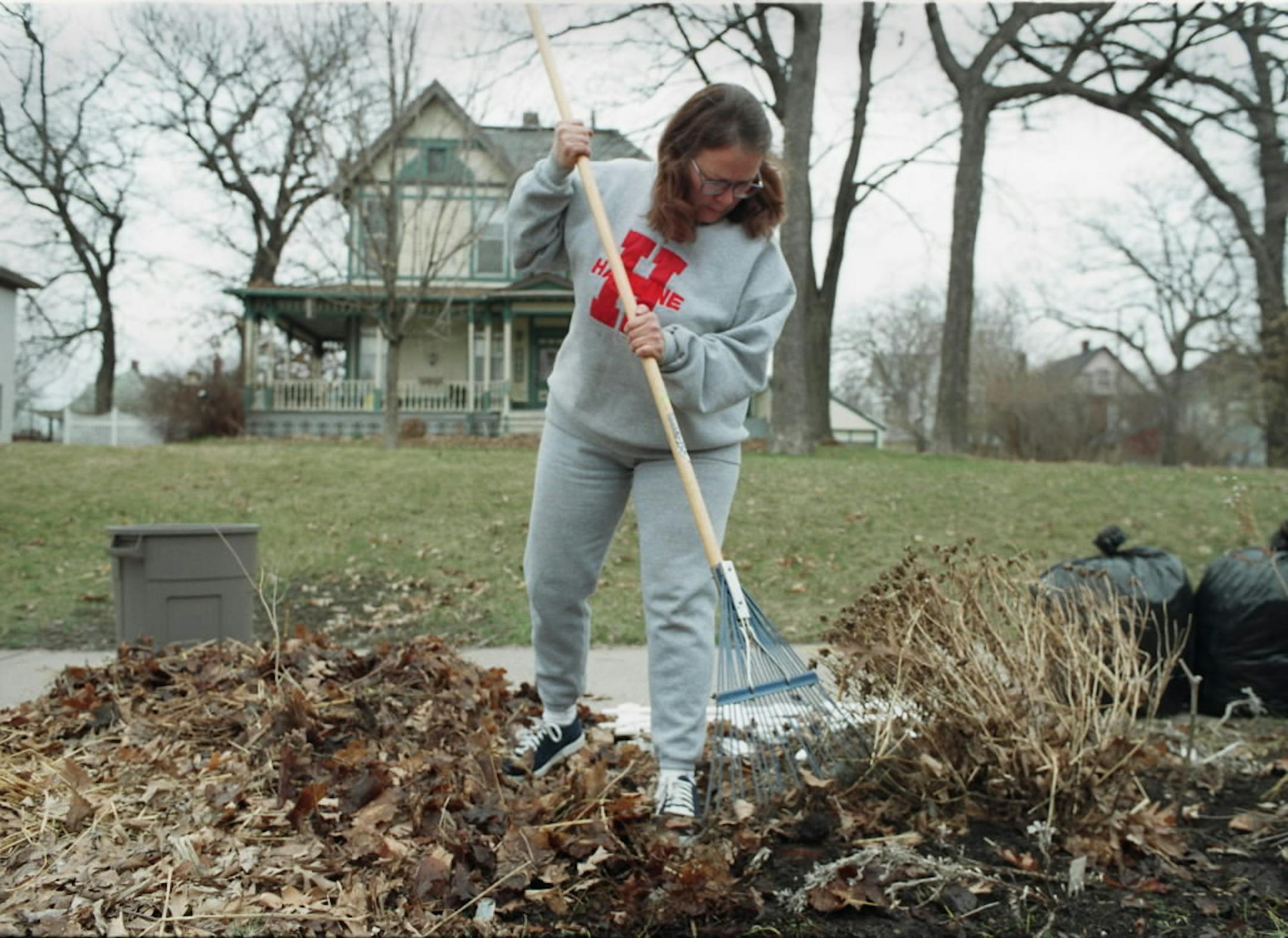 Susan Breedlove worked removing mulch in her boulevard garden.