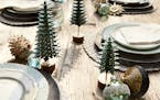 Rustic and refined table setting with layers of subtle sparkle and casual texture for warm holiday cheer.
