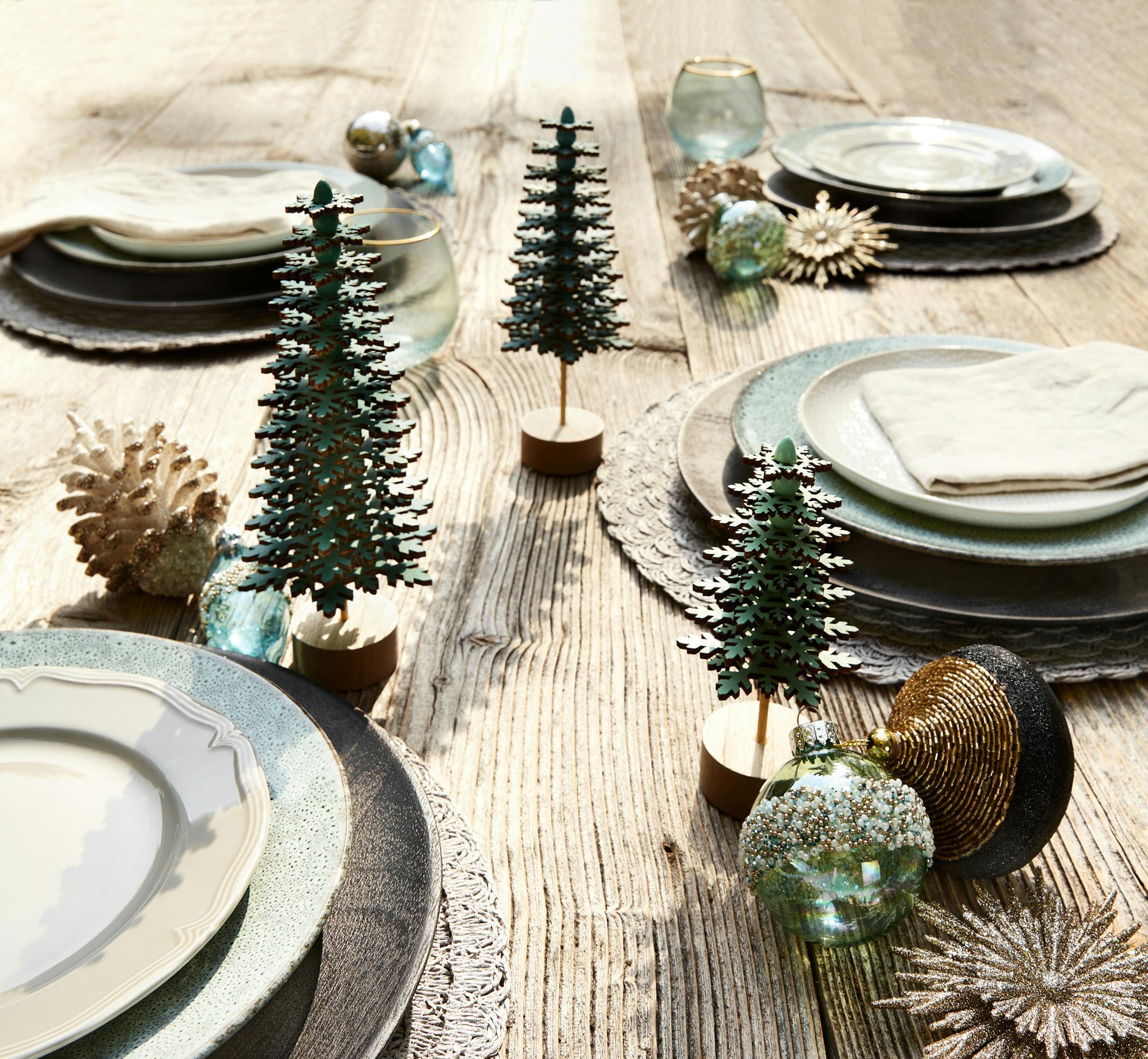 Rustic and refined table setting with layers of subtle sparkle and casual texture for warm holiday cheer.