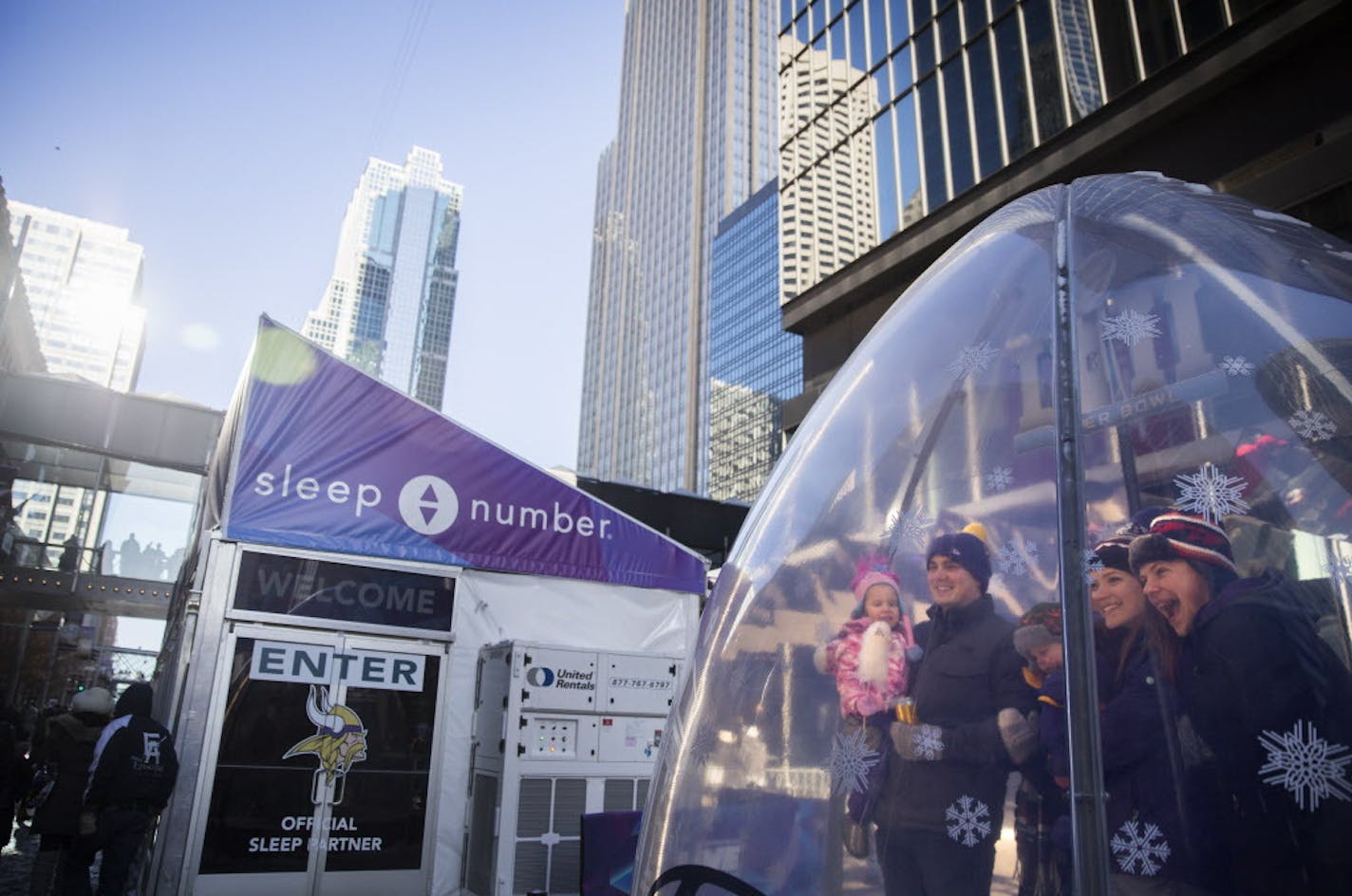 A family poses inside the football shaped snow globe on Nicollet Mall. ] LEILA NAVIDI &#x2022; leila.navidi@startribune.com BACKGROUND INFORMATION: The scene at Super Bowl Live on Nicollet Mall before the game on Sunday, February 4, 2018. Performances on Sunday included DJ Dudley D and 13 Crowns.