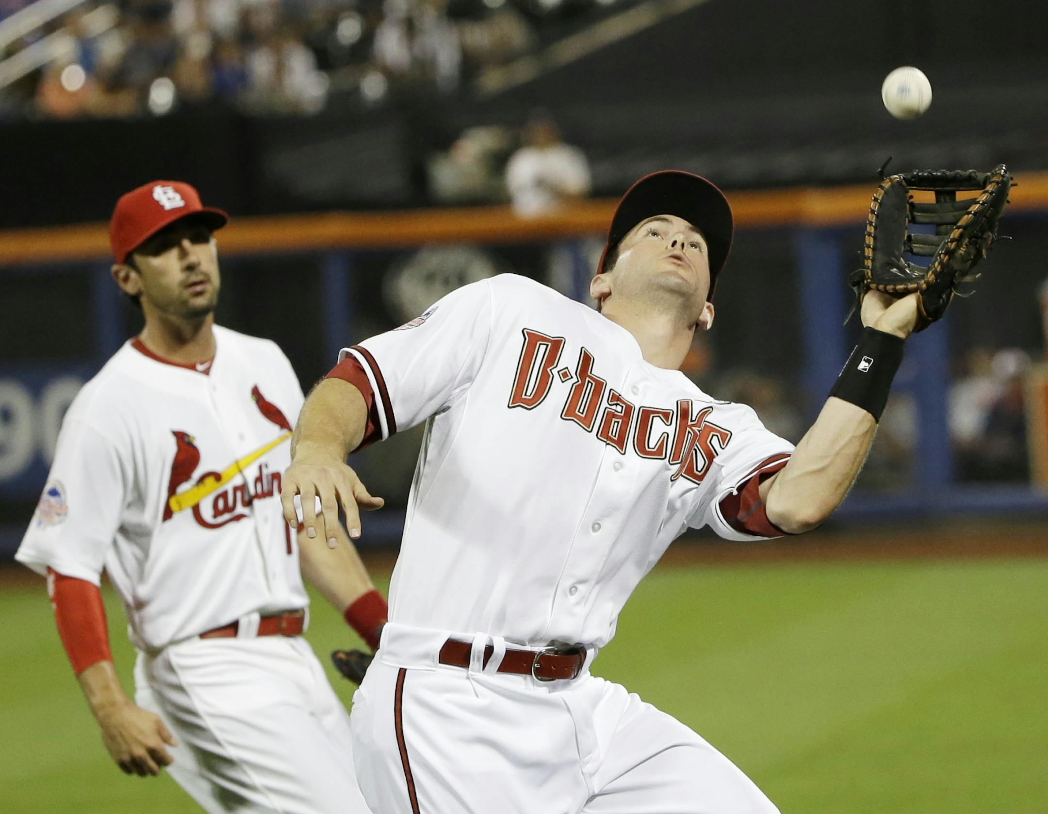 National League�s Paul Goldschmidt, right, of the Arizona Diamondbacks, catches a foul ball hit by American League�s Miguel Cabrera, of the Detroit Tigers, ?during the sixth inning of the MLB All-Star baseball game, on Tuesday, July 16, 2013, in New York.