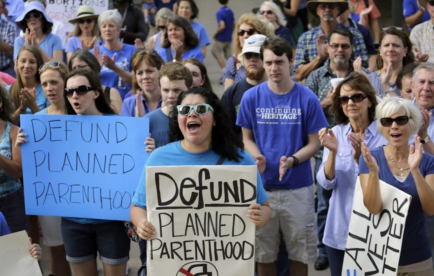 Activists rally on the steps of the State Capitol in Austin, Texas, to protest funding for Planned Parenthood in 2015.