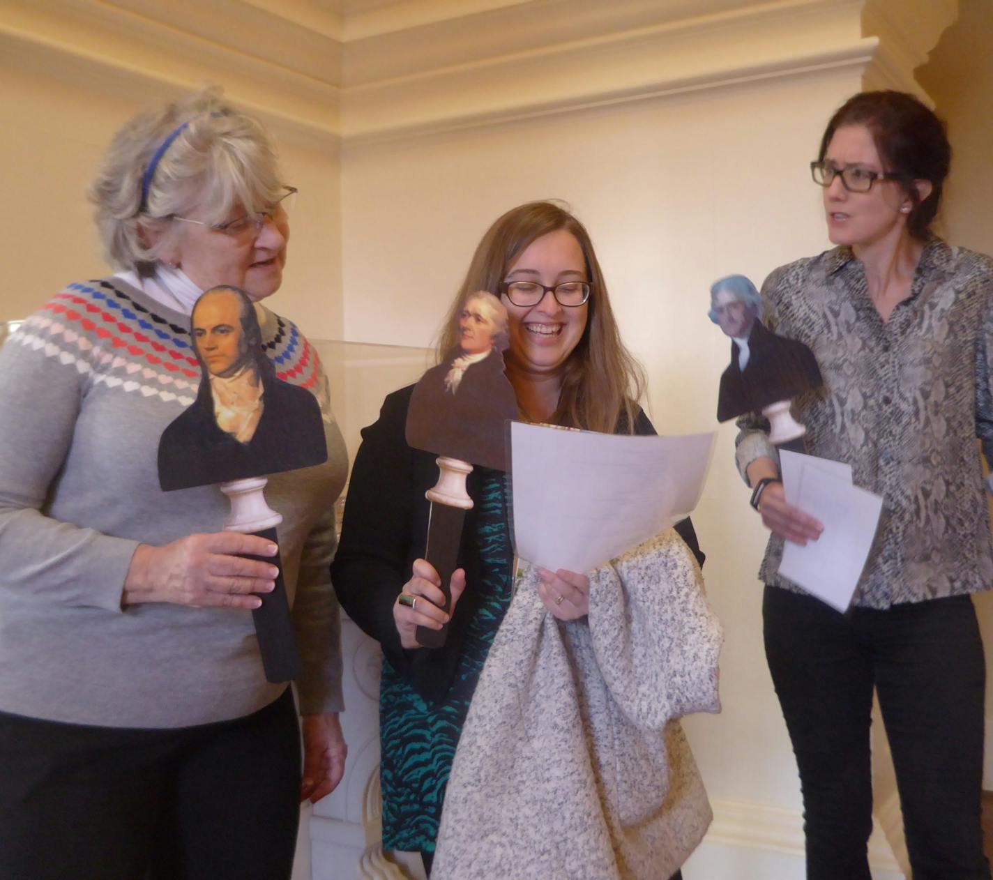 From left, Susan Seehaver, Mia Magruder and Melanie Bowyer, of Charlottesville, Va., hold Founding Fathers stick puppets of Aaron Burr, Alexander Hamilton and Thomas Jefferson, during a new Hamilton tour of Monticello. (Larry Bleiberg/Chicago Tribune/TNS)