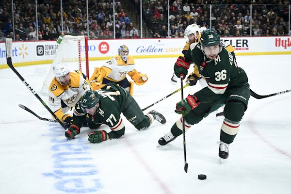 Minnesota Wild right wing Mats Zuccarello (36) took control of the puck after it was lost by defenseman Brad Hunt (77) in the second period.