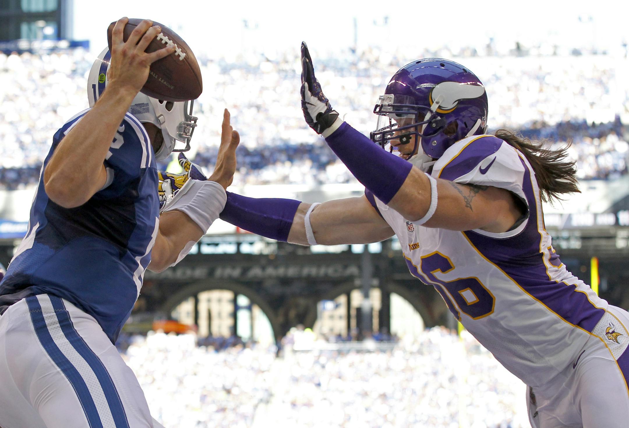 Colts quarterback Andrew Luck (12) evaded the grasp of Brian Robison (96) in the end zone in the third quarter. ] CARLOS GONZALEZ cgonzalez@startribune.com - September 16, 2012 , Indianapolis, Indiana, NFL, Lucas Oil Stadium, Minnesota Vikings vs. Indianapolis Colts