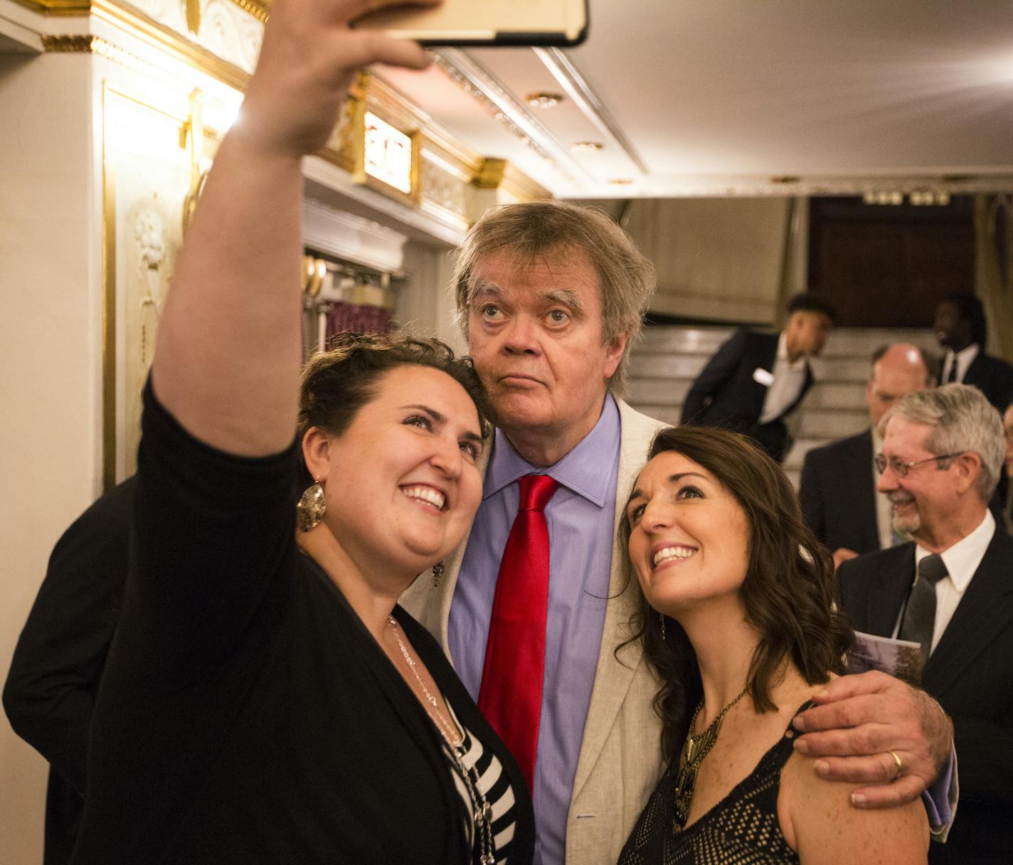 Garrison Keillor poses for a selfie with sisters Janna Graham of Plymouth, left, and Julie Berninghaus of Eagan after the show. ] (Leila Navidi/Star Tribune) leila.navidi@startribune.com BACKGROUND INFORMATION: The live broadcast for "A Prairie Home Companion" at the State Theatre in Minneapolis on Saturday, May 21, 2016. This is Garrison Keillor's last season on "A Prairie Home Companion."