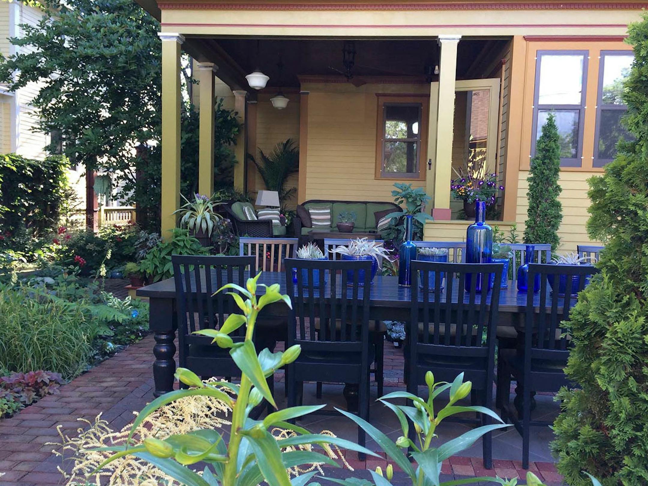 The backyard garden includes a large table for entertaining.