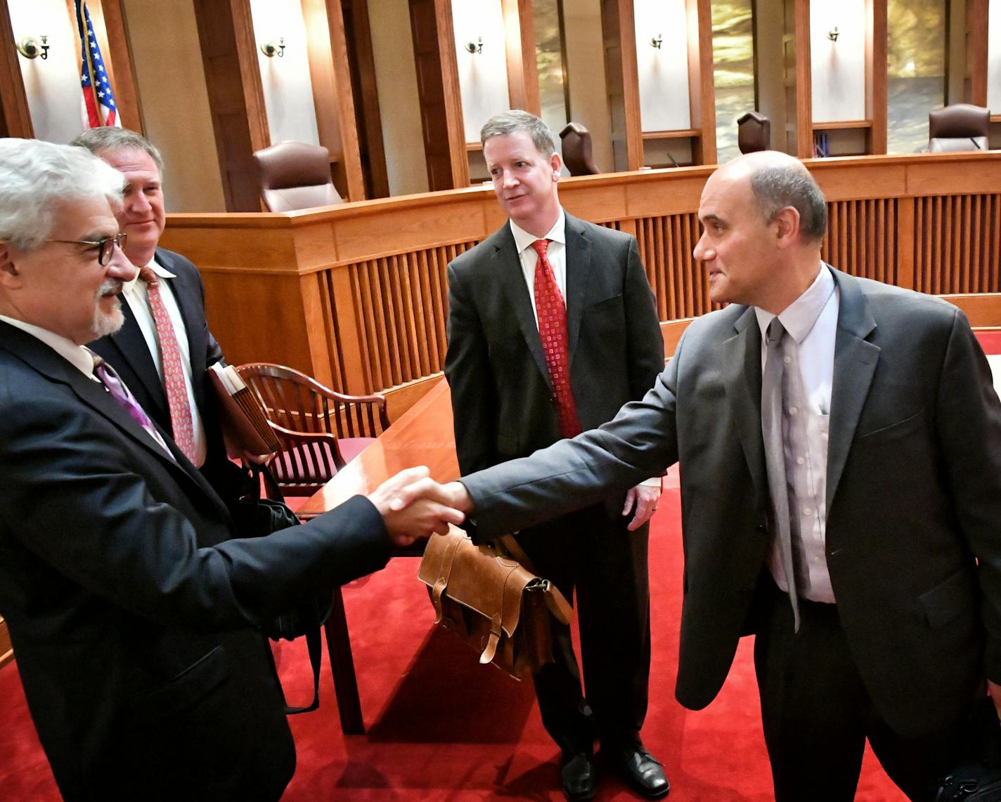 Jordan Kushner, right, the attorney representing the Committee for Professional Policing, which drafted the police insurance plan, came over to shake hands with Tim Skarda, Minneapolis assistant city attorney who opposed him in court. ] GLEN STUBBE * gstubbe@startribune.com Tuesday, August 30, 2016 The Minnesota Supreme Court heard arguments in two high-profile citizen proposals angling to get on the Minneapolis ballot this November. One that would boost the city's minimum wage to $15 per hour a