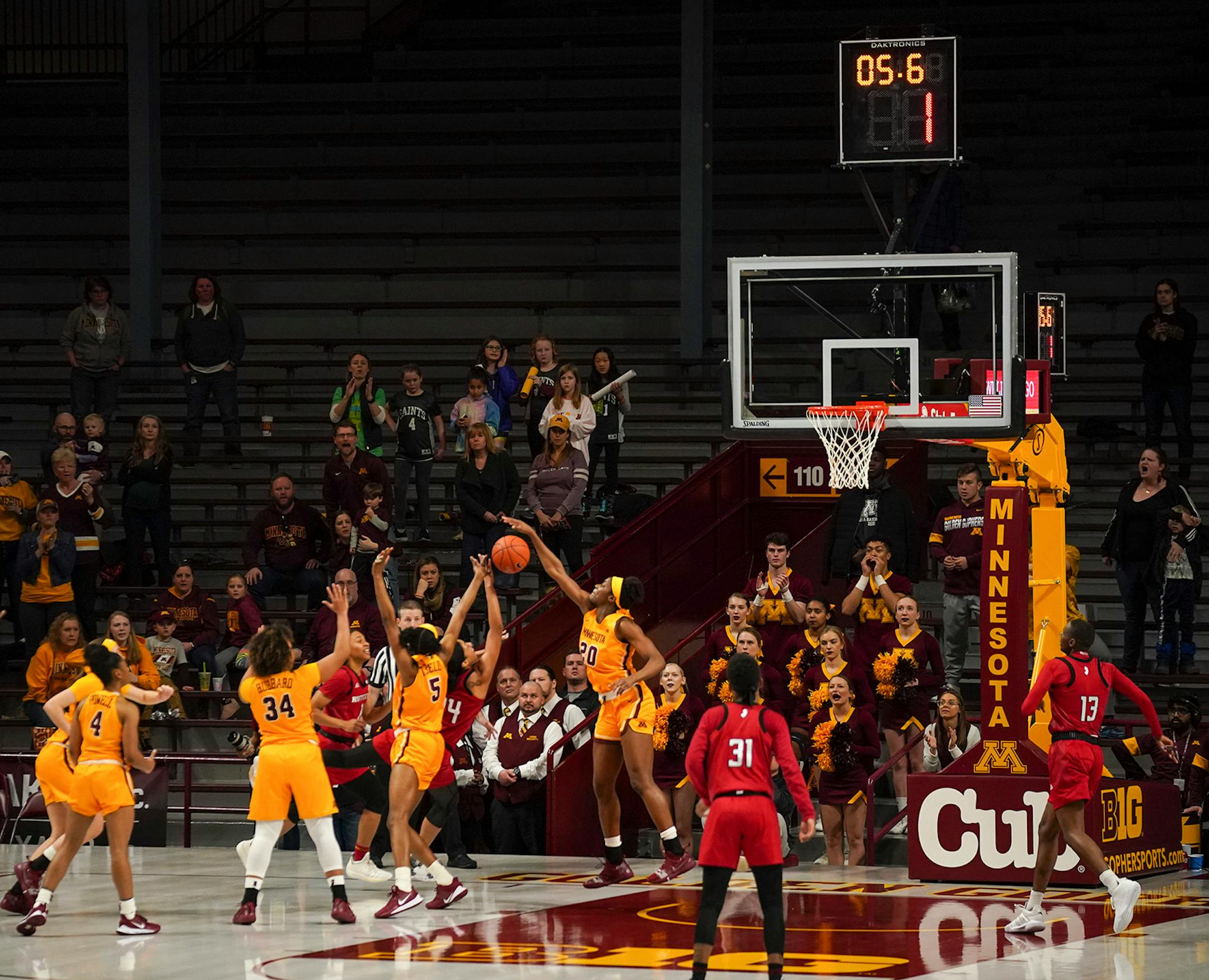 Minnesota Gophers forward Kehinde Bello (20) blocked a shot by Rutgers Scarlet Knights guard Arella Guirantes (24) with under six seconds left to send the game into the second overtime.