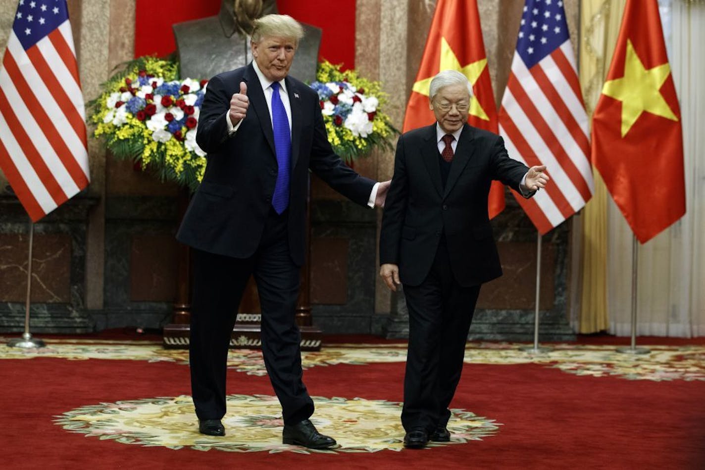 President Donald Trump walks with Vietnamese President Nguyen Phu Trong at the Presidential Palace, Wednesday, Feb. 27, 2019, in Hanoi.