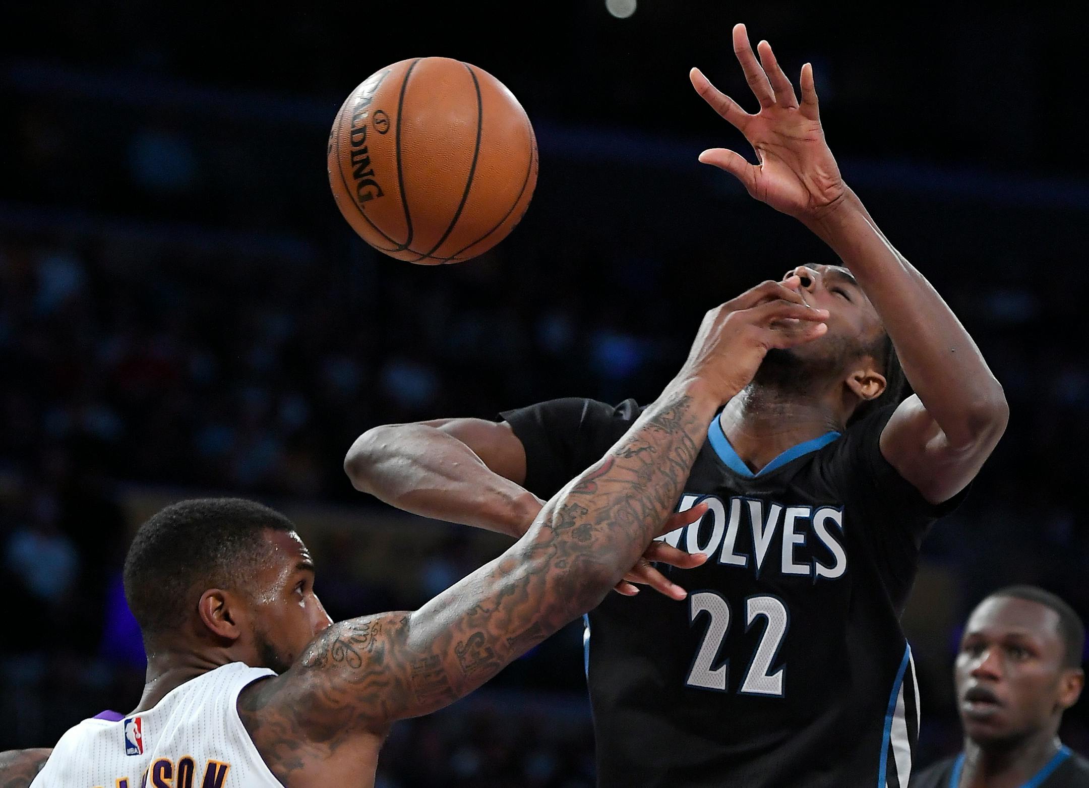 Timberwolves forward Andrew Wiggins, right, was hit in the face by Lakers forward Thomas Robinson as he tried to shoot during the first half Sunday. Wiggins scored a game-high 41 points, but the Wolves still lost 110-109 in Los Angeles.