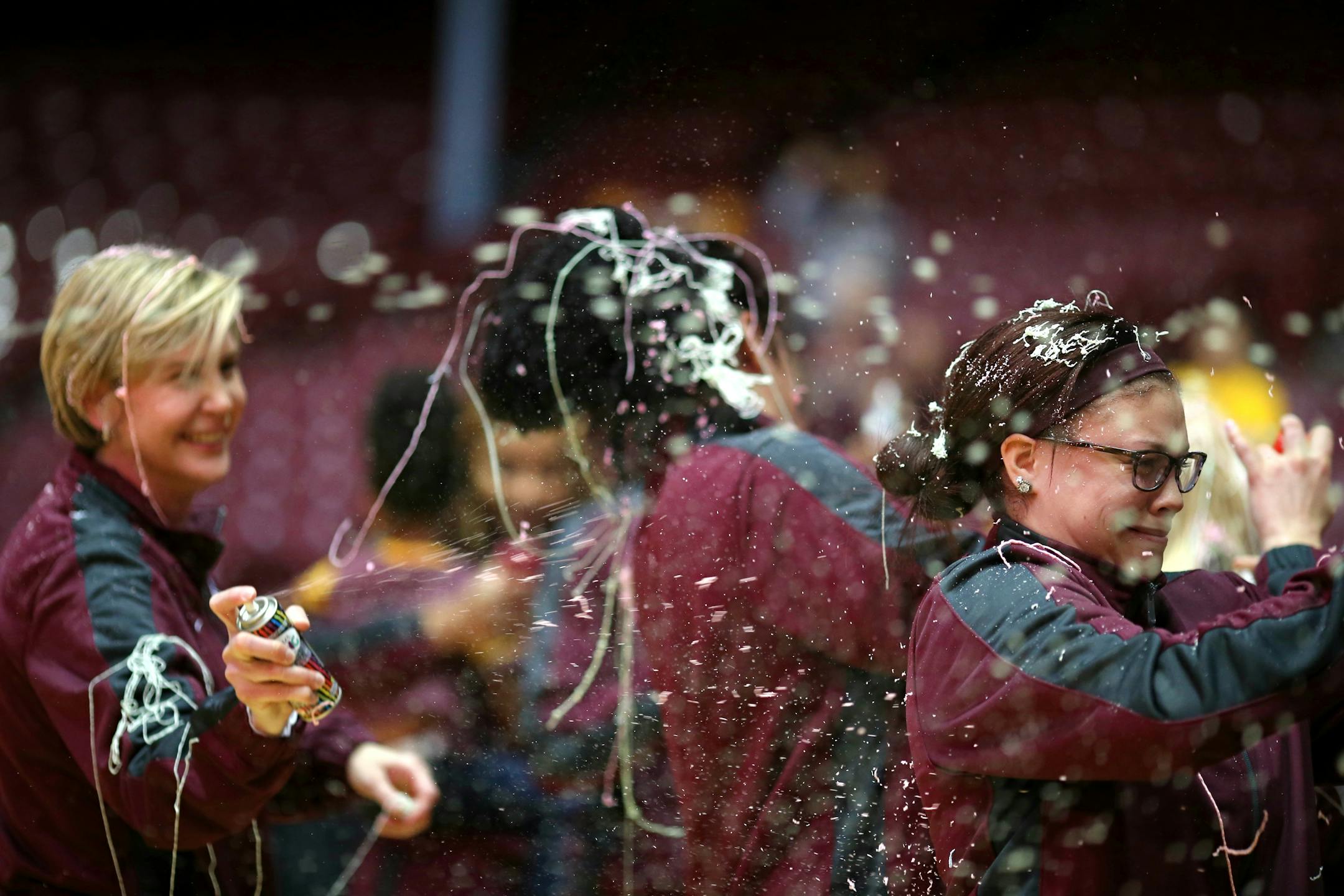 Gophers coach Marlene Stollings, left, and her players, including the injured Rachel Banham, right, celebrated with Silly String after learning their NCAA tournament opponent and destination.