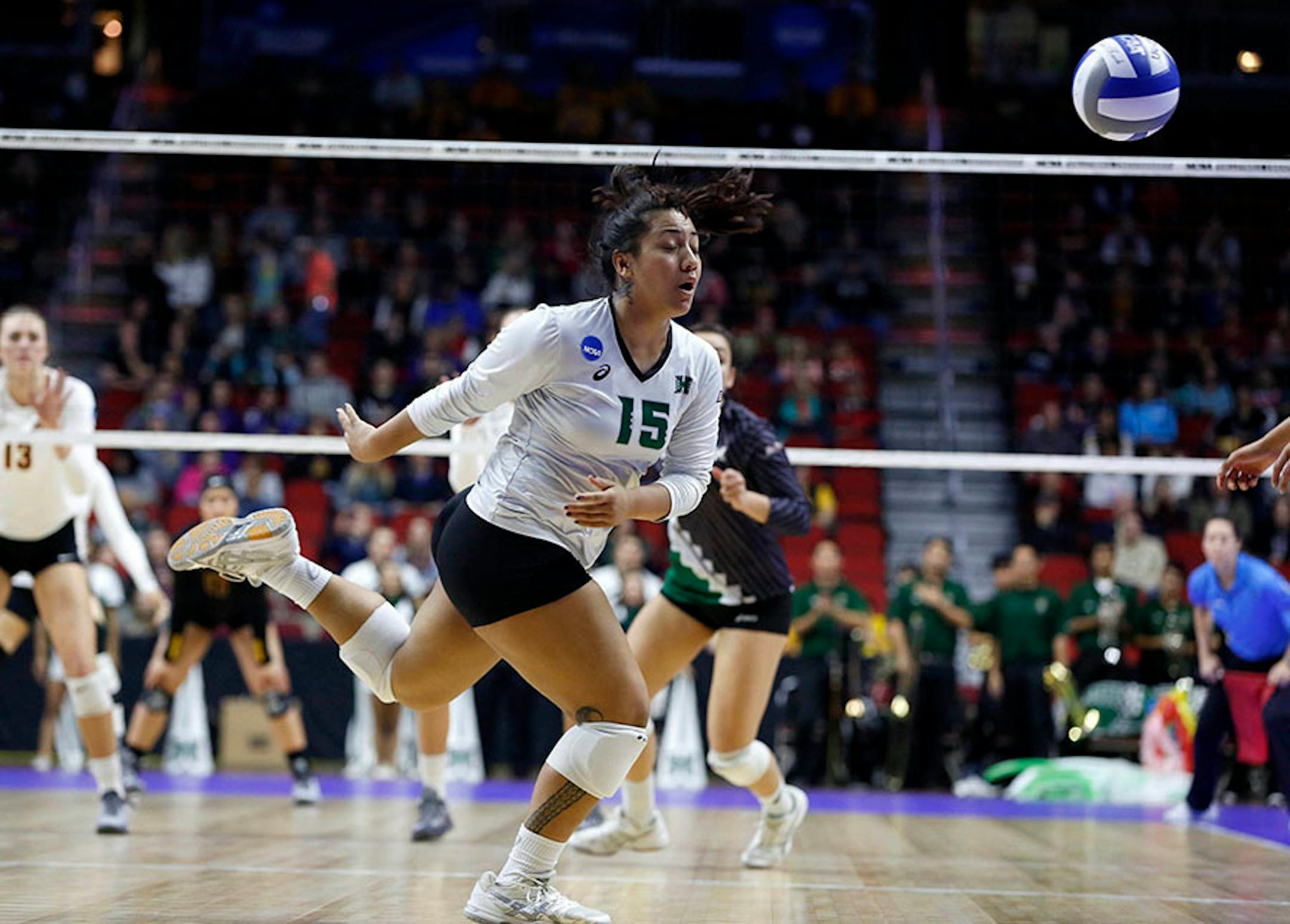 Hawaii's Savanah Kahakai (15) knocks the ball back resulting in a point for Minnesota Saturday, Dec. 12, 2015, during the NCAA Division I Women's Volleyball Championship.
