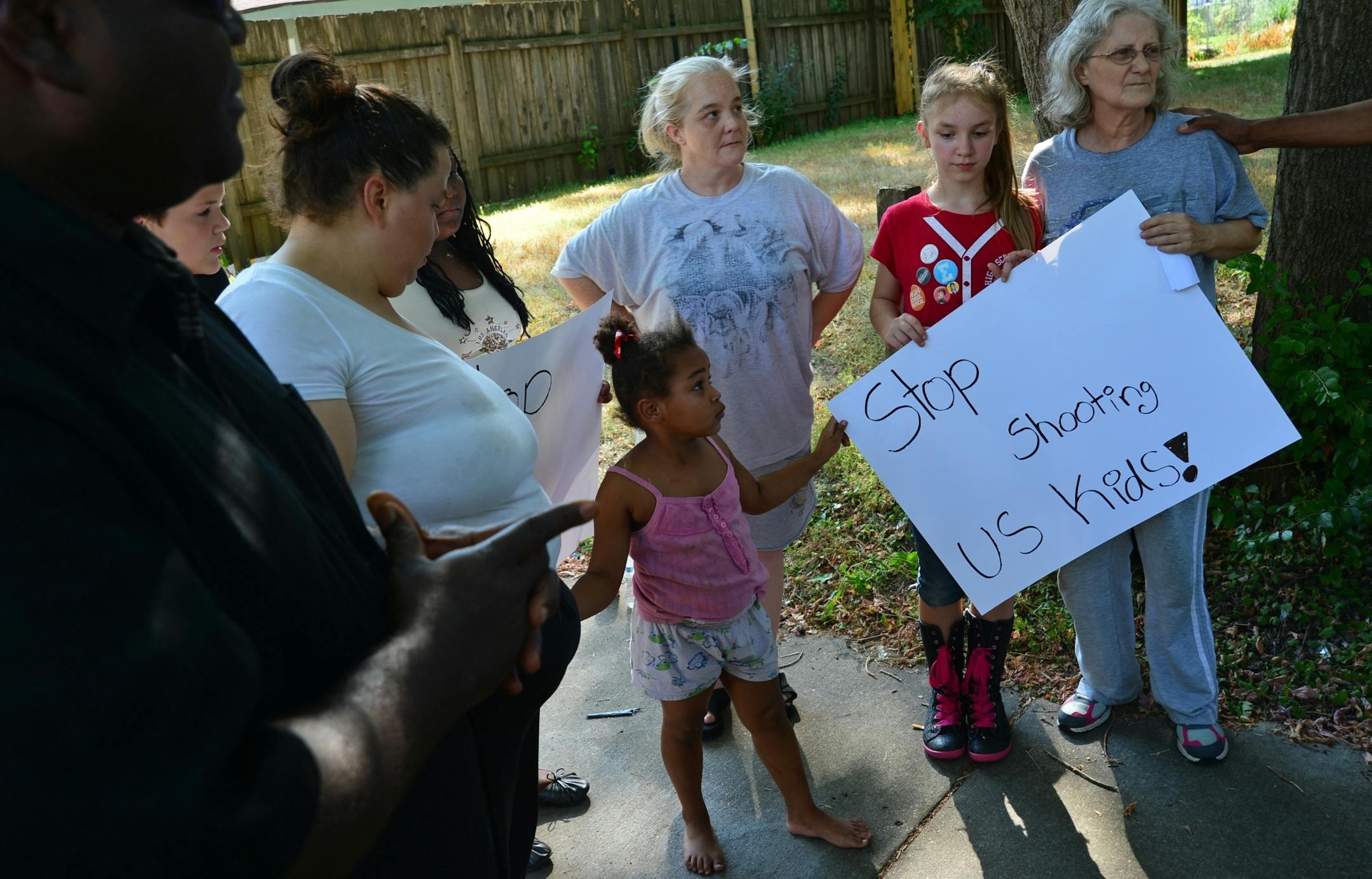 Neighbors near the shooting scene came together to pray and condemn both the shooting and the easy availability of guns in north Minneapolis.
