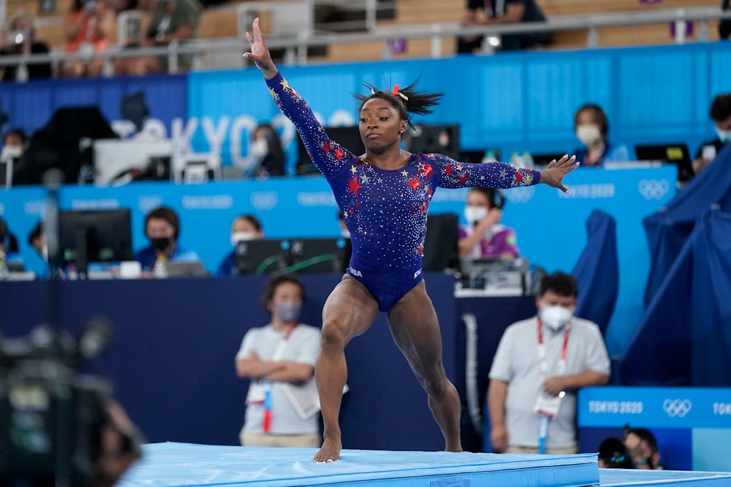 Simone Biles steps off the mat on a vault landing, one of a rash of mistakes for the U.S. team Sunday. 