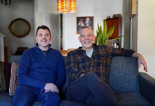 Rob Kirby, left, author of the graphic memoir “Marry Me a Little,” with his husband John Capecci at their St. Paul home.