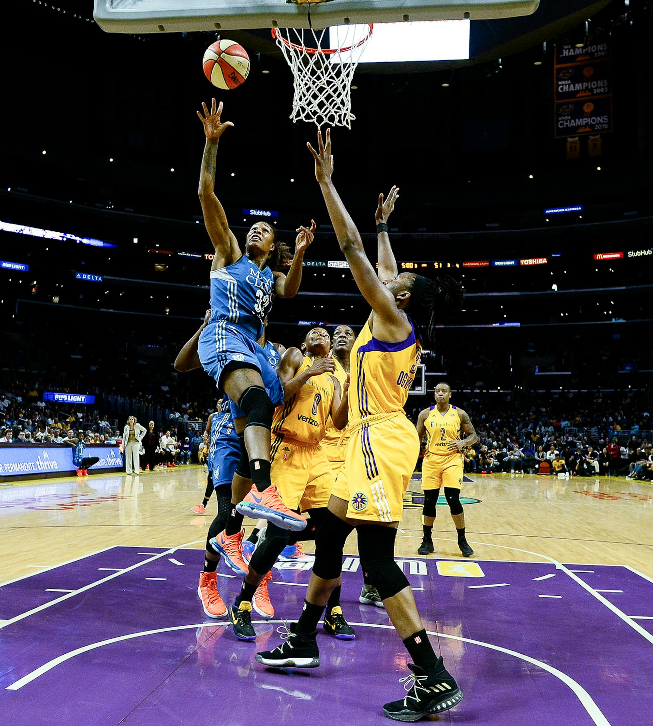 Minnesota Lynx forward Rebekkah Brunson (32) scored a second half layup despite the defense of Los Angeles Sparks guard Alana Beard and forward Nneka Ogwumike (30) in the second half.