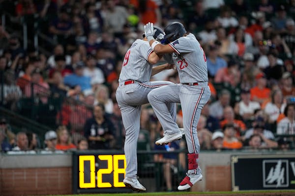 Minnesota Twins' Royce Lewis (23) celebrates with Alex Kirilloff after both scored on Lewis' three-run home run against the Houston Astros during the 