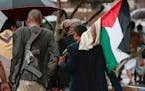 Houthi supporters carry a Palestinian flag as they walk during a rally against the U.S. and Israel and to support Palestinians in the Gaza Strip, in S
