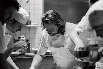 Magnus Nilsson and crew plating Porridge of grains and seeds from Jämtland finished with a lump of salty butter. Photograph: Erik Olsson ORG XMIT: MI