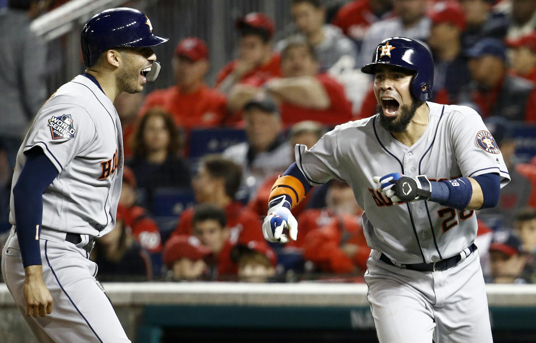 Houston Astros' Robinson Chirinos, right, celebrates his two-run home run with Carlos Correa during the fourth inning of Game 4 of the baseball World Series against the Washington Nationals Saturday, Oct. 26, 2019, in Washington. (AP Photo/Patrick Semansky)
