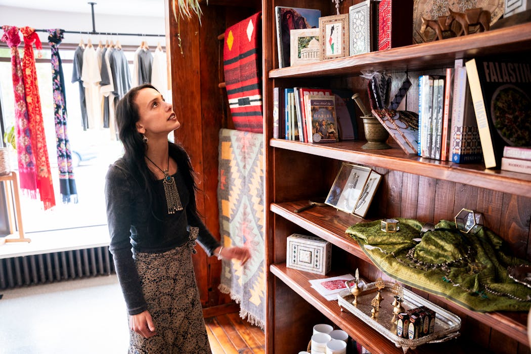 Falastin co-owner Lyla Abukhodair looks at items from her newly-opened storefront on East Superior Street in Duluth. The owners import much of their ingredients, goodies, books and art pieces from Palestine through their family members who still live there. 