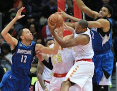 Atlanta Hawks' Al Horford gets the defensive rebound against Minnesota Timberwolves' Tayshaun Prince, left, and Karl-Anthony Towns, right, during the 