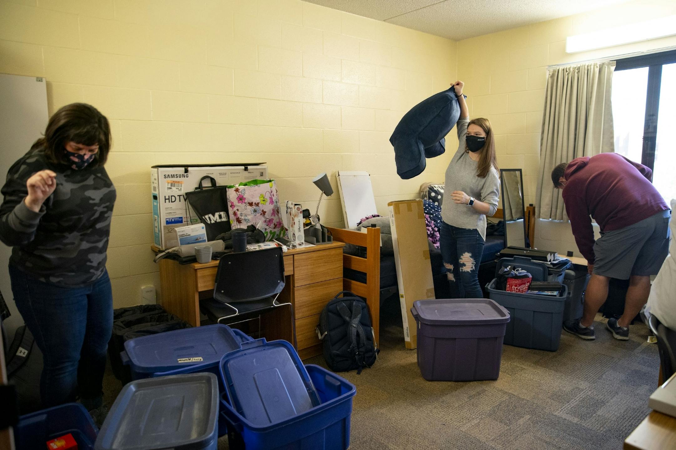Riley Krenz, an freshman Chemistry major from Rosemount, MN, and her parents, Molly and Todd, worked on unpacking Riley's belongings in her room in Ianni Hall on Thursday during move-in at UMD.