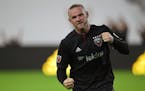 D.C. United forward Wayne Rooney celebrates his first MLS goal during the first half of a soccer match against the Colorado Rapids in Washington, Satu