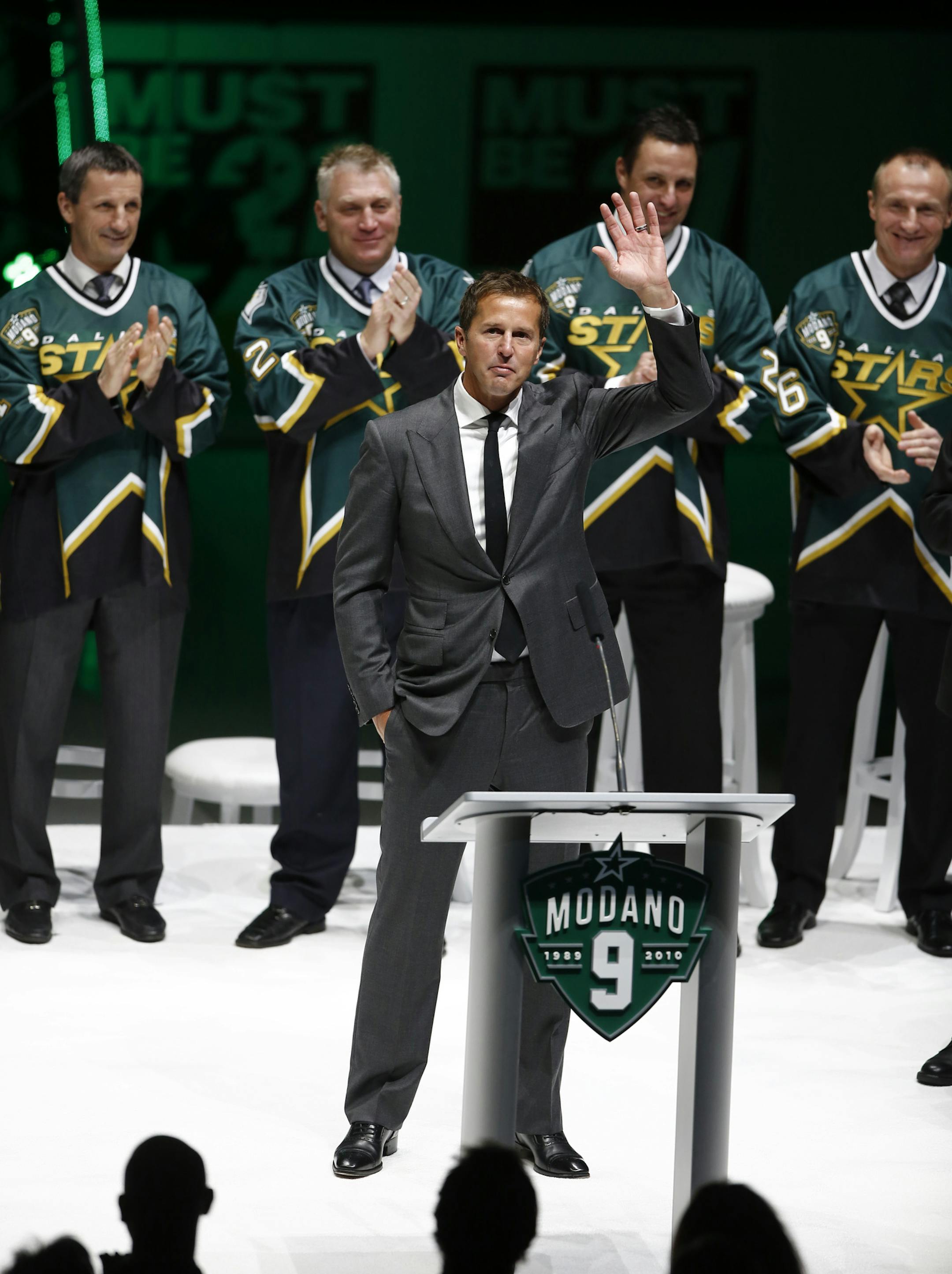 Former Dallas Star Mike Modano waves to the crowd during his jersey retirement ceremony before the NHL hockey game between the Stars and the Minnesota Wild on Saturday, March 8, 2014, in Dallas. (AP Photo/The Dallas Morning News, Nathan Hunsinger) MANDATORY CREDIT; MAGS OUT; TV OUT; INTERNET USE BY AP MEMBERS ONLY; NO SALES