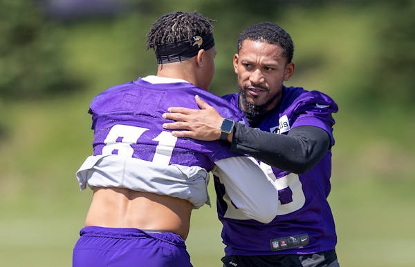 Vikings wide receiver Albert Wilson, right, gets a hug from Bisi Johnson on Wilson’s first day with the team. 