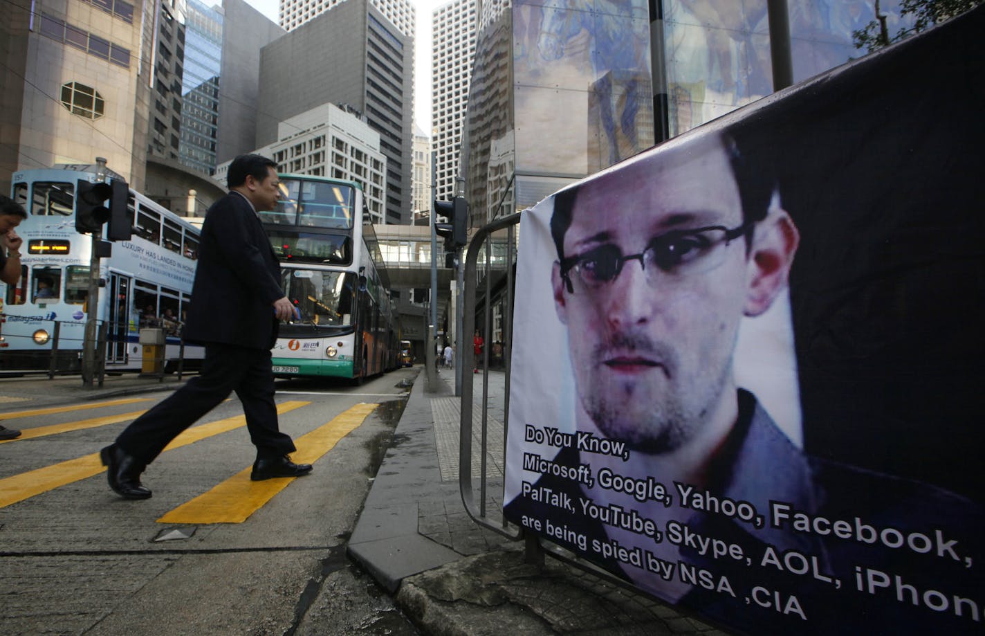 A banner supporting Edward Snowden, a former CIA employee who leaked top-secret documents about sweeping U.S. surveillance programs, is displayed at Central, Hong Kong's business district, Monday, June 17, 2013.