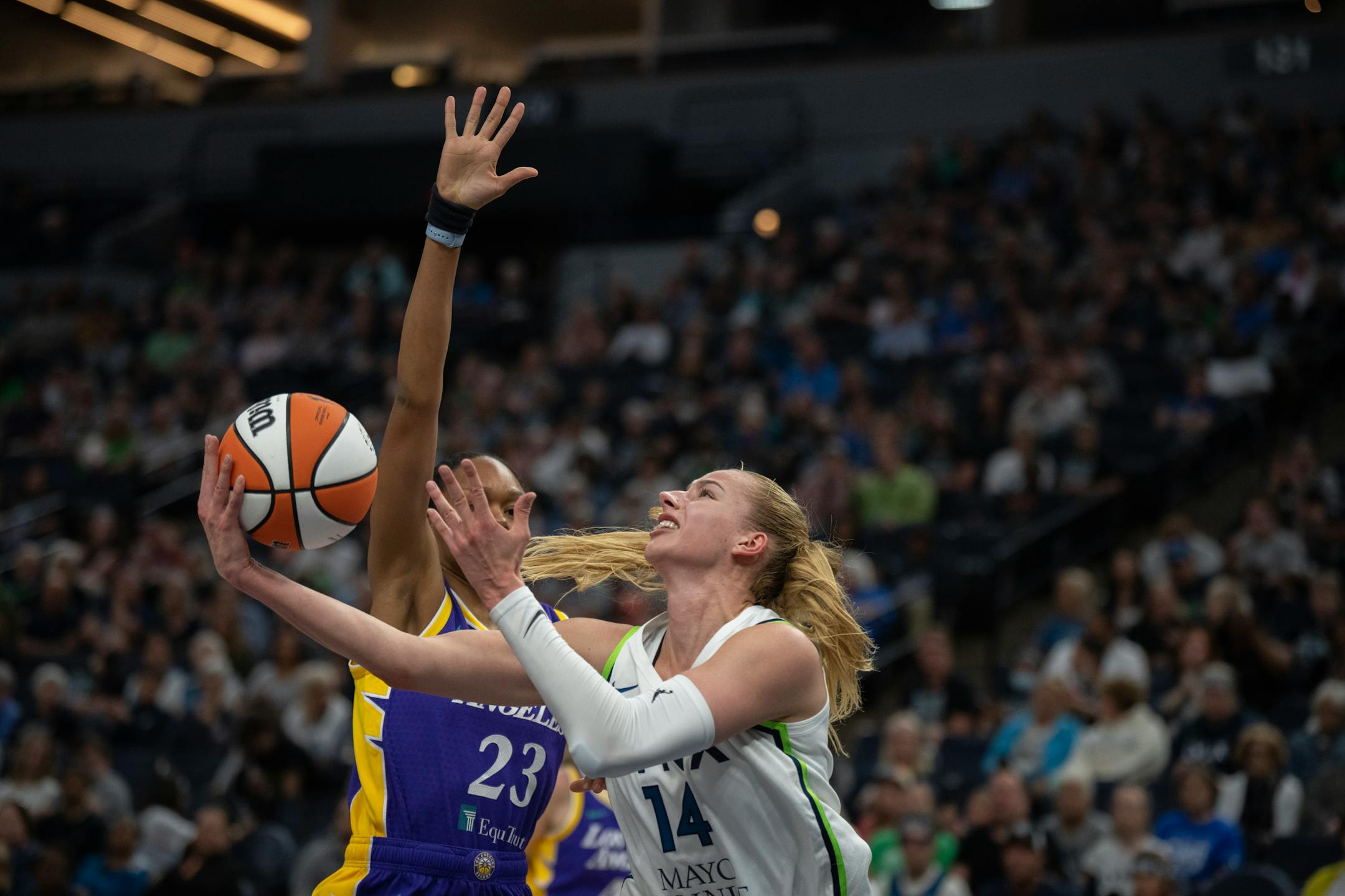 Minnesota Lynx forward Dorka Juhasz (14) tried to score over Los Angeles Sparks forward Azura Stevens (23) in the first half.